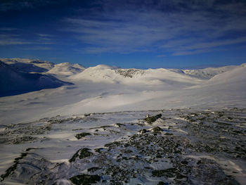 Scenic view of snowcapped mountains against sky