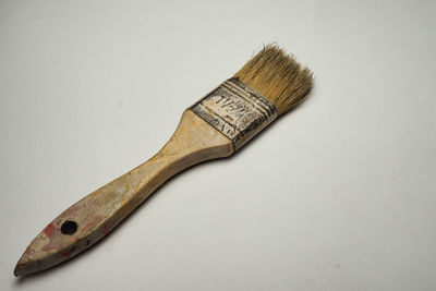 High angle view of paintbrushes against white background