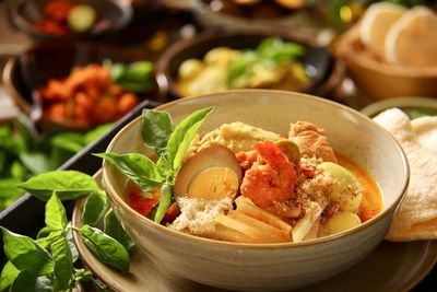 Lontong cap go meh, the peranakan dish of rice cake with chicken curry soup, spicy shrimps, tea egg