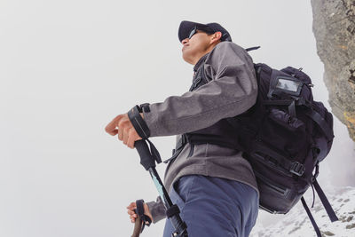 Low angle view of man holding camera