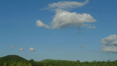 Scenic view of land against blue sky