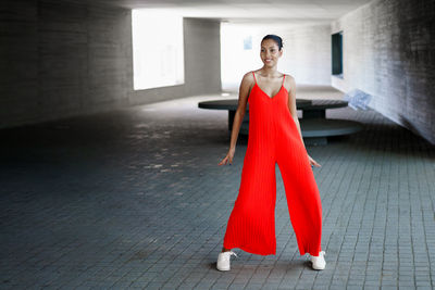 Full length of young woman walking on street