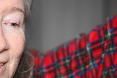 Close-up of smiling woman looking away at home