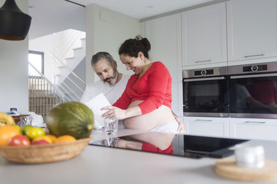 People having food in kitchen at home