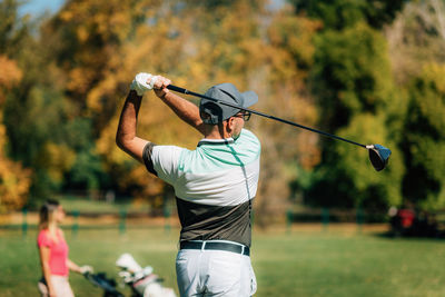 Golf couple, playing on the golf course