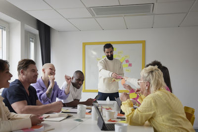 Diverse team brainstorming during business meeting in conference room