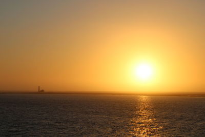 Scenic view of sea against orange sky