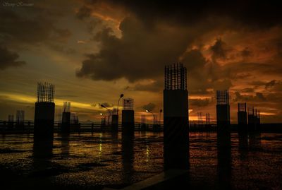 Construction site against orange cloudy sky during monsoon