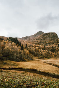 Scenic view of field with mountains and small rivers against sky