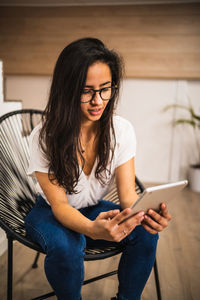 Beautiful young woman using mobile phone