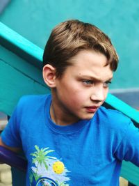 Cute boy looking away while standing at playground