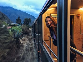 Portrait of woman peeking through train window