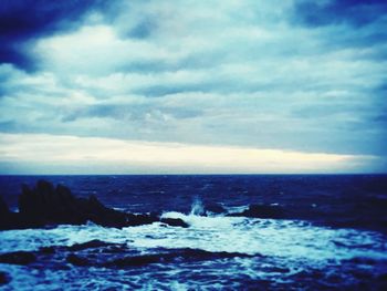 Scenic view of sea against cloudy sky