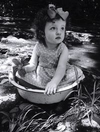 Portrait of girl sitting in water