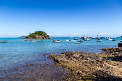 Scenic view of sea against clear blue sky