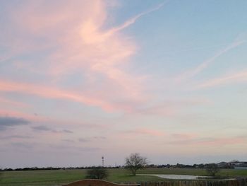 Scenic view of field against sky at sunset