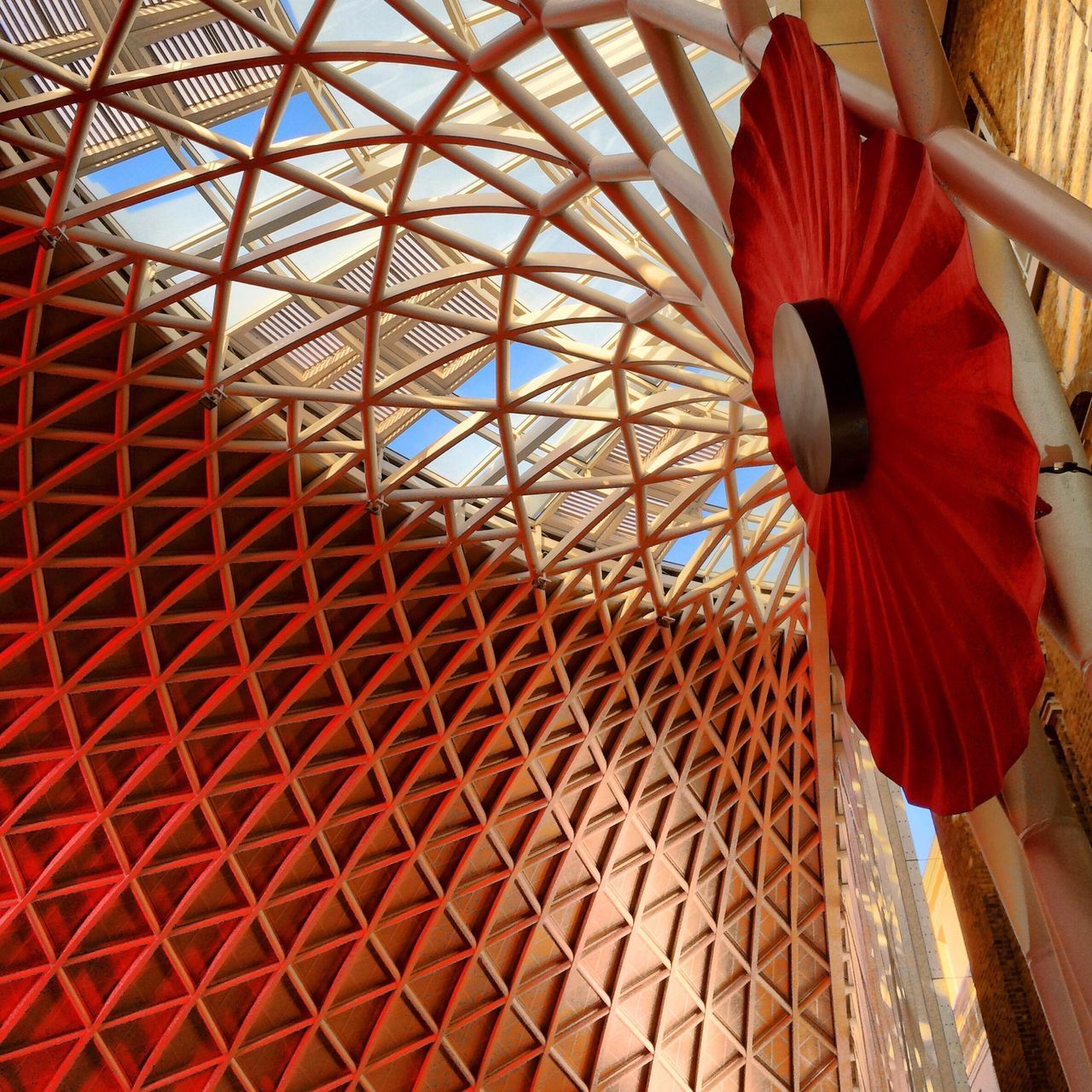 low angle view, pattern, built structure, architecture, red, design, indoors, ceiling, no people, umbrella, day, decoration, orange color, metal, arts culture and entertainment, sunlight, building exterior, multi colored, close-up