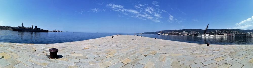 Panoramic view of sea against blue sky