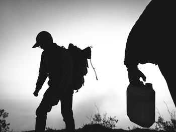 Silhouette man standing on field against clear sky