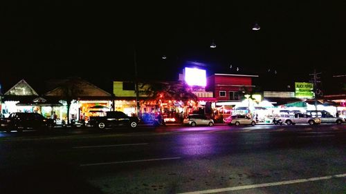 Illuminated city street at night