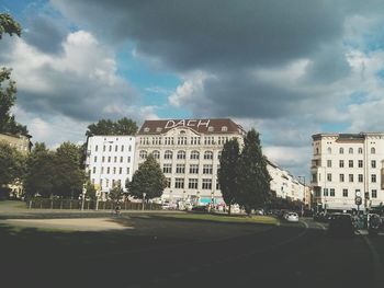 Buildings against cloudy sky