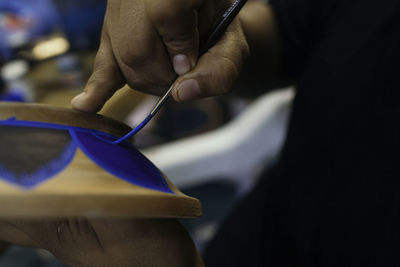 Mexican artist painting pottery