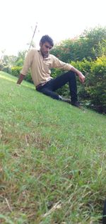 Young man sitting on field