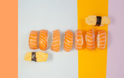Directly above shot of cupcakes on table against white background