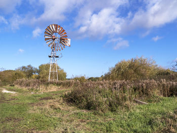 Rusty old wind pump at wheldrake ings nature reserve in north yorkshire, england