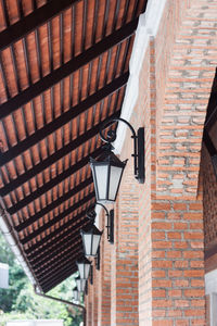 Low angle view of street light against building