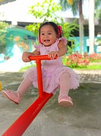 Portrait of boy sitting on slide