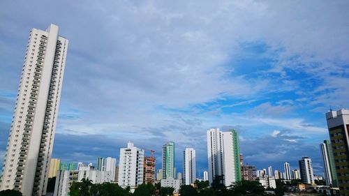 Low angle view of modern building against cloudy sky