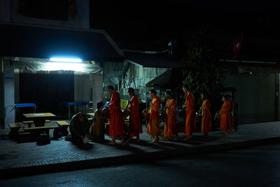 People in illuminated room at night