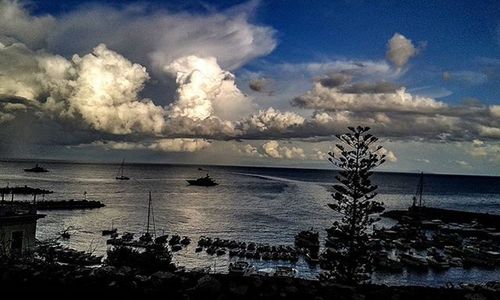 Scenic view of sea against cloudy sky