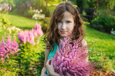 Portrait of girl with pink flower
