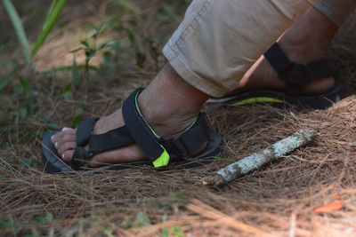 Low section of man relaxing on field