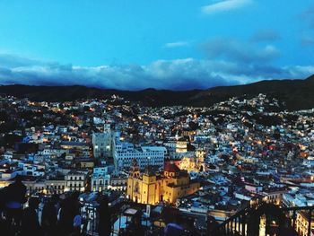 High angle view of illuminated cityscape against sky at night