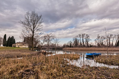 Scenic view of lake by buildings against sky