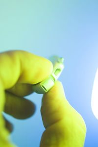 Close-up of hand holding yellow leaf