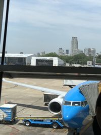 Airplane on runway against sky