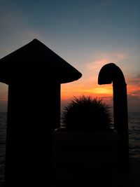 Silhouette built structure against sky during sunset