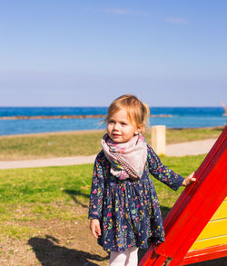 Portrait of smiling woman standing on beach