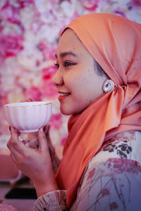 Portrait of woman holding ice cream