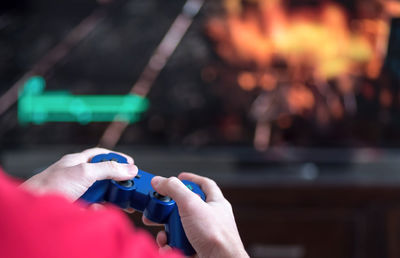 Close-up of hands holding video game remote control