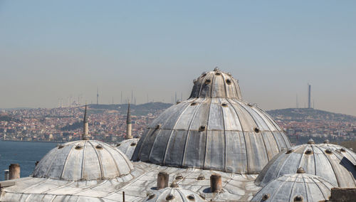 Panoramic view of buildings in city against clear sky