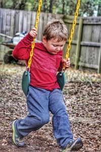 Boy on swing in park
