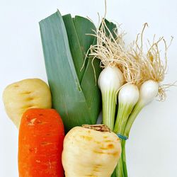 Close-up of vegetables on table against white background