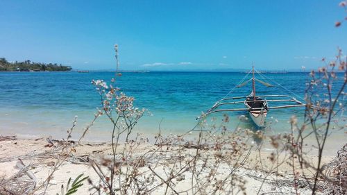 Scenic view of sea against clear blue sky