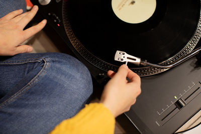 Midsection of woman playing turntable