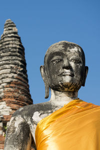 Low angle view of statue against clear blue sky during sunny day